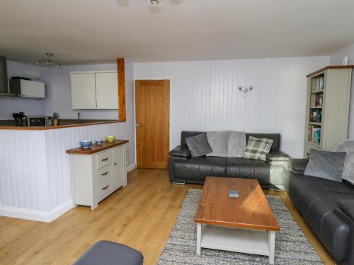 a living room with a couch and a table at 1 St Marys Court in Tenby