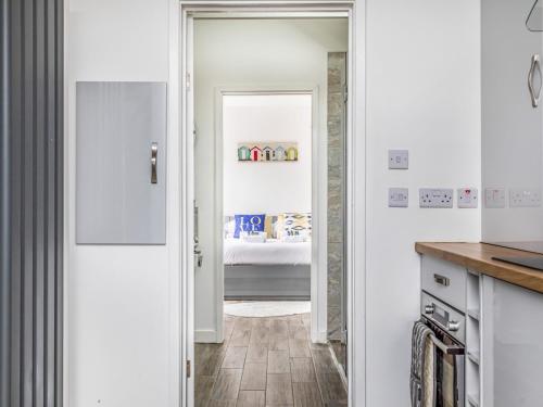 a kitchen with a door leading to a bedroom at Pass the Keys Charming Annexe w Garden Parking Pass The Keys in Chichester