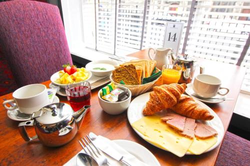 a table with a breakfast of bread and croissants at Castle Hotel in Dublin