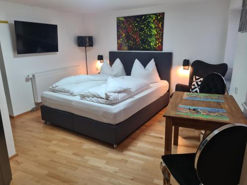 a bedroom with a bed and a table and a table sidx sidx sidx at Gästeapartment Pfaff in Rottweil