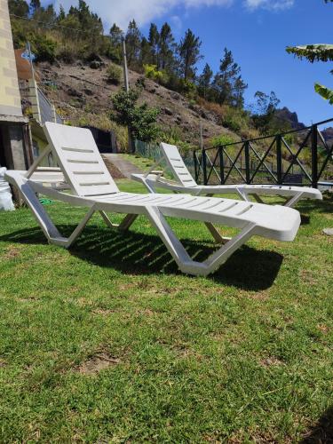 two white lawn chairs sitting on the grass at CILAOS 360° in Cilaos