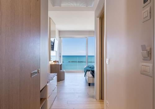 a hallway with a room with a view of the ocean at Hotel Savini in Bellaria-Igea Marina