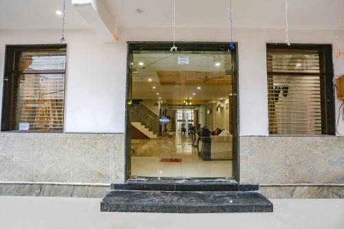 a glass door of a building with people in it at FabExpress Taj Residency - Nr Yashobhoomi Convention Centre in New Delhi