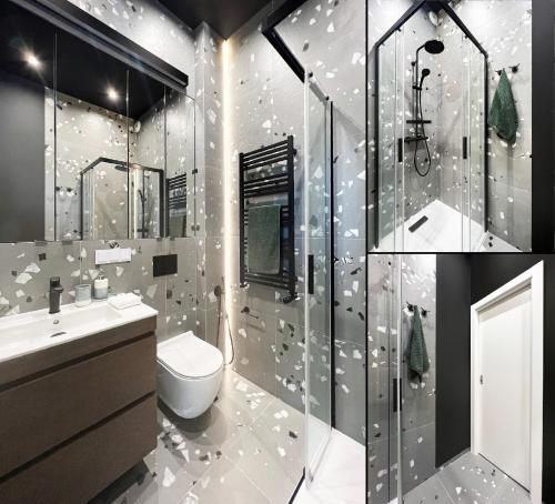 a bathroom with a shower and a toilet and a sink at AboutArtApartments - By the river in Wrocław