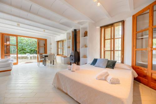 a bedroom with a large bed and a living room at Villa Can Sarrio in Sant Carles de Peralta