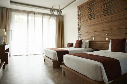 a hotel room with two beds and a window at Up Town Hotel in Cairo