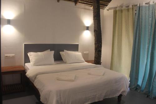 Postel nebo postele na pokoji v ubytování Agonda Beach Chalets