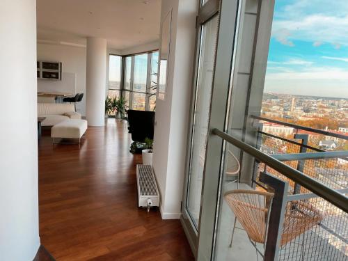 a living room with a view of a city at Panoramic Apartment Vilnius in Vilnius