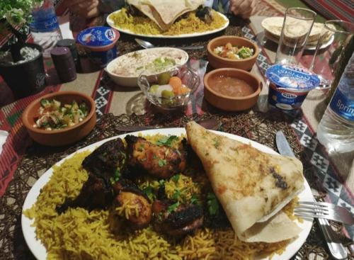 a table with plates of food on a table at Majido Hotel in Wadi Musa