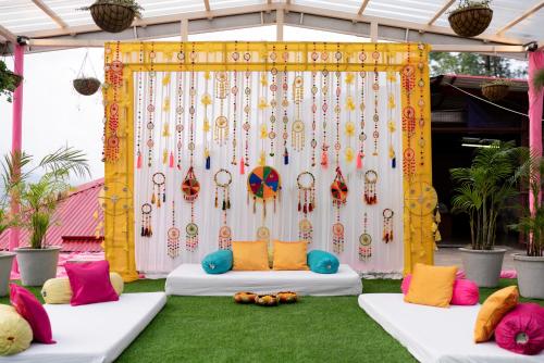 a marquee with two beds with colorful pillows on the grass at 8fold by LaRiSa in Shimla