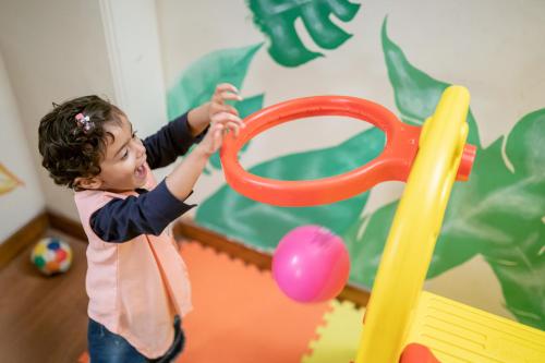 a little girl playing with a toy in a play set at 8fold by LaRiSa in Shimla