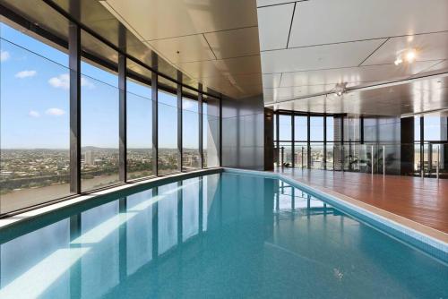 a swimming pool in a building with a view at Amazing City &River views 60th level skytower 3 bedrooms&Free parking in Brisbane
