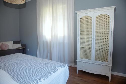 a bedroom with a bed and a white cabinet at La Torre de Guardiola in Guardiola de Berguedà