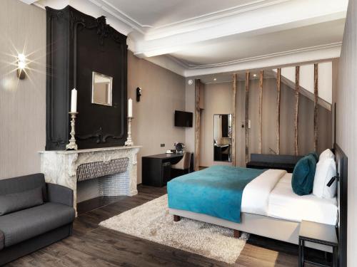 a bedroom with a bed and a fireplace at Hotel Harmony in Ghent