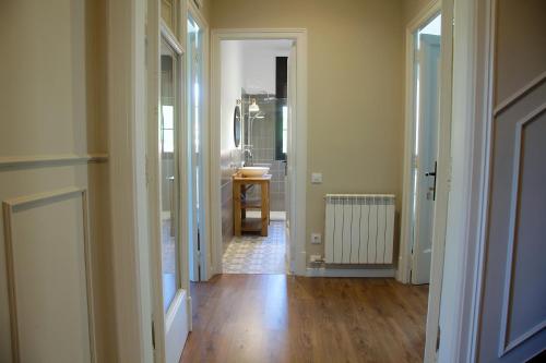 a hallway with a bathroom and a sink in a room at La Torre de Guardiola in Guardiola de Berguedà