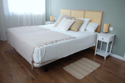 a bedroom with a large bed and a night stand at La Torre de Guardiola in Guardiola de Berguedà