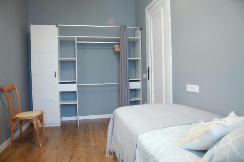 a bedroom with a bed and a sliding glass door at La Torre de Guardiola in Guardiola de Berguedà