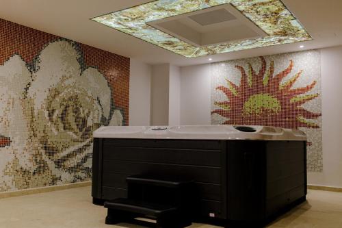 a bathroom with a sink and a mirror on the wall at Muller Hotel Boutique & Spa in Galaţi