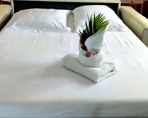 a white bed with a pineapple on a towel at Nature Paradise Pool & Spa - Exceptional Secluded Luxury Location in Le Diamant