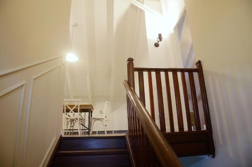 a hallway with a staircase with a light and a table at La Torre de Guardiola in Guardiola de Berguedà