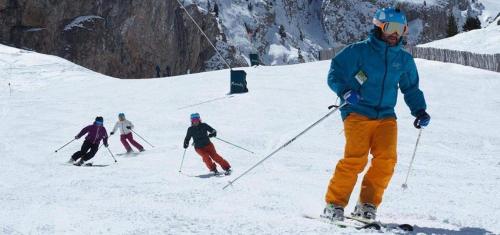 a group of people skiing down a snow covered slope at La Torre de Guardiola in Guardiola de Berguedà
