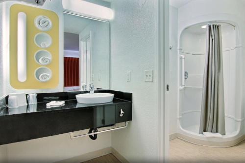 a bathroom with a sink and a mirror at Motel 6-Corpus Christi, TX - East - North Padre Island in Corpus Christi