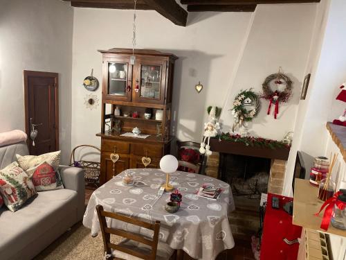 uma sala de estar com uma mesa e um sofá em La casina in Via Fiorita em Montepulciano