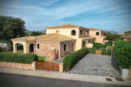 a large house with a fence in front of it at Ville del Mar in San Teodoro