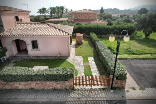 a house with a fence and a street light at Ville del Mar in San Teodoro