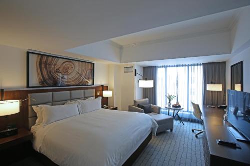 a hotel room with a large bed and a desk at Intercontinental Real Guatemala by IHG in Guatemala