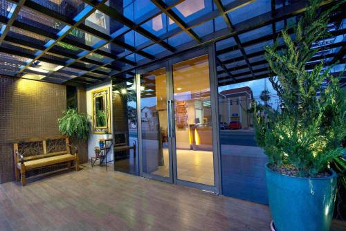 an indoor patio with a glass door and potted plants at Carppa Hotel in Fortaleza