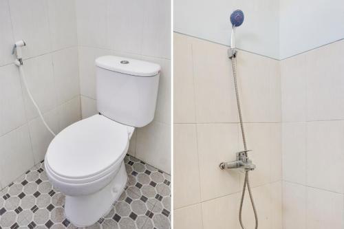 a white toilet in a bathroom with a shower at OYO 91926 Serayu Sumbersari Homestay in Jenggrik