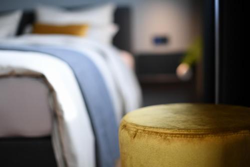 a close up of a stool in front of some beds at Hotel Nice in Laupheim