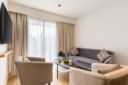 a living room with a couch and a table at Best Western Plus Casablanca City Center in Casablanca