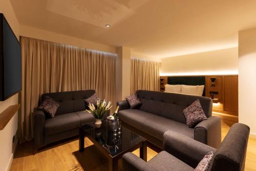 a living room with two couches and a couch at Best Western Plus Casablanca City Center in Casablanca