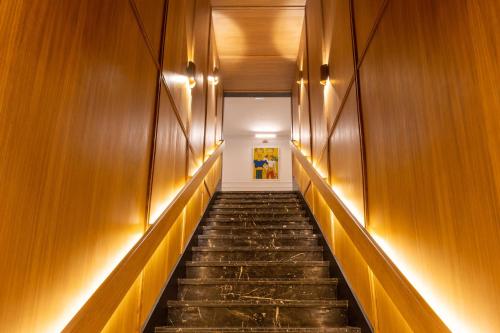 a hallway with wooden walls and stairs with lights at Best Western Plus Casablanca City Center in Casablanca