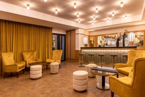 a waiting room with yellow chairs and a bar at Best Western Plus Casablanca City Center in Casablanca