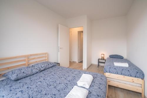 a bedroom with two beds in a room at Opera Square Apartments in the Center of Antwerp in Antwerp