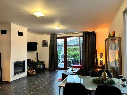 a living room with a fireplace and a tv at Relaxklub villa s wellness in Třemošná