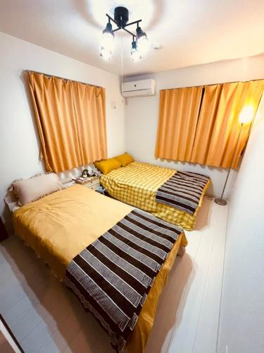 Cama o camas de una habitación en 羽田ハウスⅡ