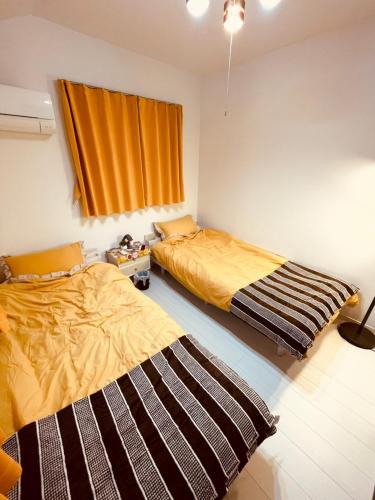 Cama o camas de una habitación en 羽田ハウスⅡ