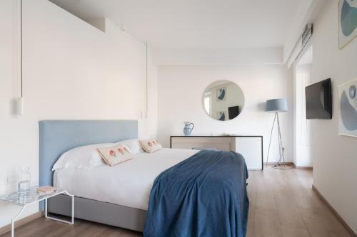 a white bedroom with a bed and a mirror at Domo 20 Hotel & Rooftop in Vico Equense