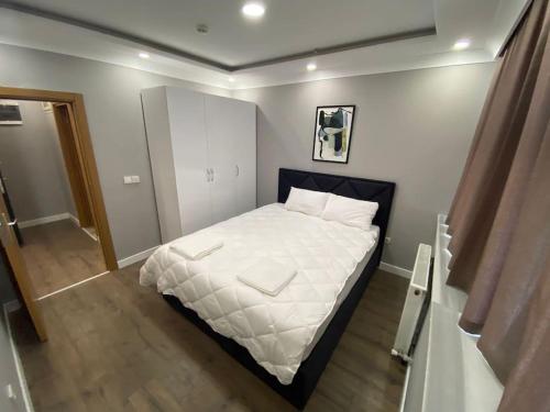 a small bedroom with a bed with white sheets at Atasuit2 in Istanbul