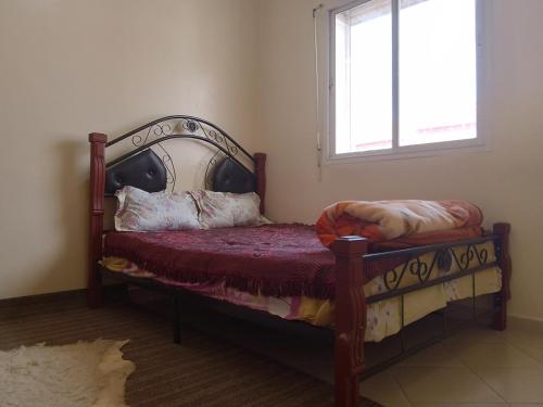 a bedroom with a bed and a window at Coisy and Calm appartment in Hay Salam, Agadir in Agadir
