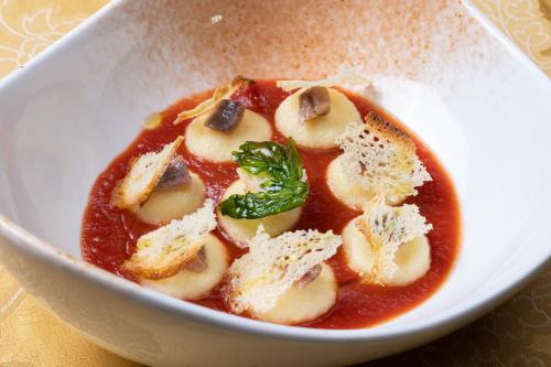 a white bowl of food with a bowl of soup at Hotel Palace in Catanzaro Lido