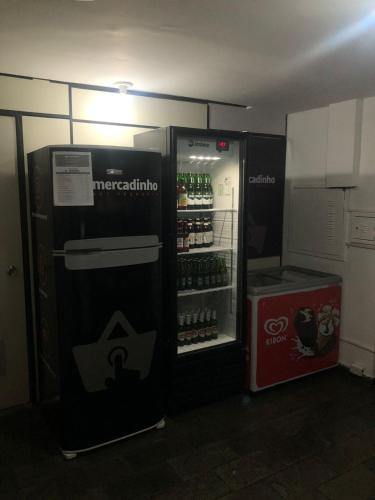 a refrigerator with drinks in it in a room at Apart Hotel Volpi 101 - Conforto & Comodidade in Belo Horizonte