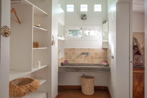 a bathroom with a sink in a room at La Kazaka Terre Sainte in Saint-Pierre