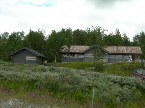 two houses on a hill with a car in front at Svarthamar - cabin with amazing view in Ål