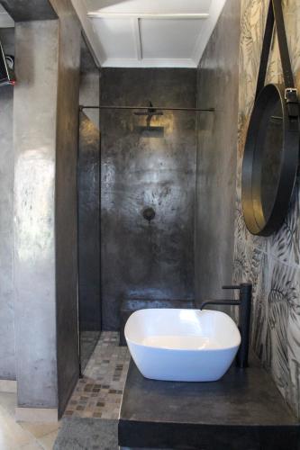 a bathroom with a white tub and a shower at A Step Ahead in Klerksdorp
