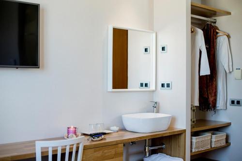 a bathroom with a white sink and a mirror at Voramar in Benicàssim